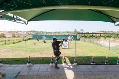 a man standing under a green tent with cones at Casa Lomy - Boavista Resort and Spa in Quatro Estradas