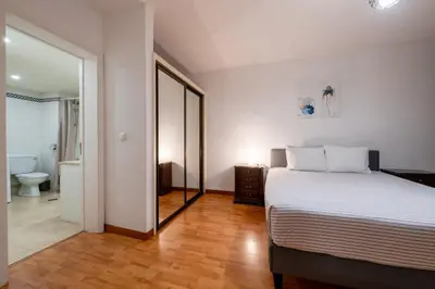 a kitchen with white cabinets and a white refrigerator at Atlantic Edge - Relaxing Beachfront Escape Formosa in Funchal