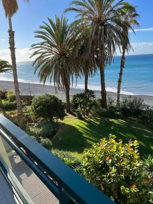 a living room with a table and a couch at Atlantic Edge - Relaxing Beachfront Escape Formosa in Funchal