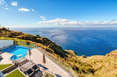 an ocean view from a house with a swimming pool at The Cliffhouse by LovelyStay in Fajã da Ovelha