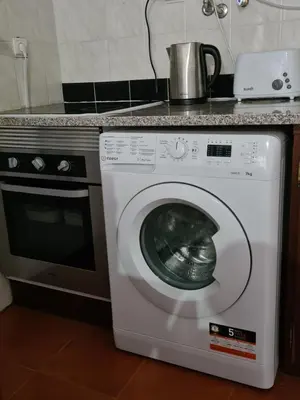 a washing machine with a pot on top of it at Scenic Comfort D in Ponta Delgada