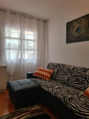 a living room with a couch and a window at Scenic Comfort D in Ponta Delgada