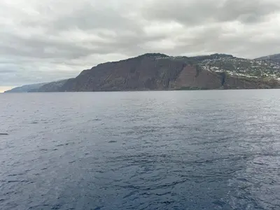 a large body of water with a mountain in the background at Desertas View Apartment in Machico