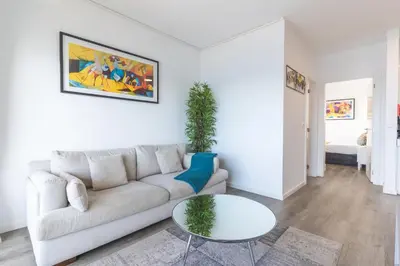 a white living room with a couch and a table at Belle Vue Résidence by Atlantic Holiday in Santa Cruz