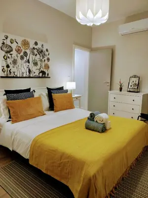 a bedroom with a large bed with a teddy bear on it at Anjos's Choice in Ponta do Sol