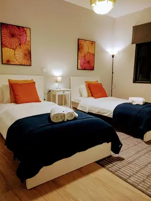 a bedroom with two beds with towels on them at Anjos's Choice in Ponta do Sol