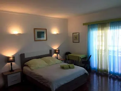 a bedroom with a bed and a table and a window at Lagos Room Booking in Lagos