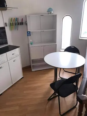 a kitchen with a white table and two chairs at Lagos Room Booking in Lagos
