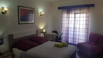 a bedroom with a bed with a yellow stuffed animal on it at Lagos Room Booking in Lagos