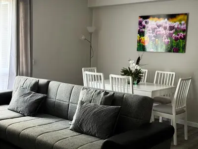 a living room with a couch and a table with chairs at Maria's Central View in Funchal