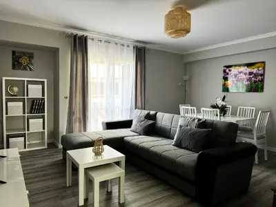 a living room with a couch and a table at Maria's Central View in Funchal