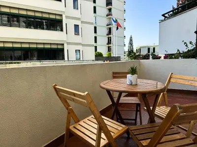 a table and chairs on a balcony with a table at Maria's Central View in Funchal