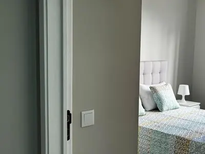 a door leading to a bedroom with a bed at Maria's Central View in Funchal