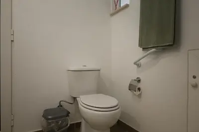 a bathroom with a white toilet in a stall at Casa das Feiteiras by AnaLodges in Ponta Delgada