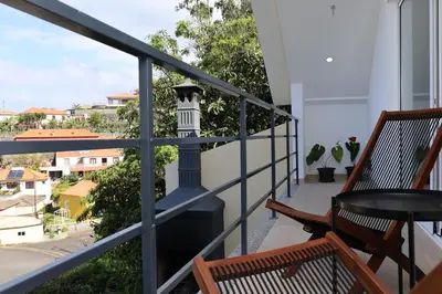a balcony with a view of a city at Casa das Feiteiras by AnaLodges in Ponta Delgada