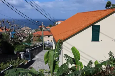 an orange roof of a white building with an orange roof at Casa das Feiteiras by AnaLodges in Ponta Delgada