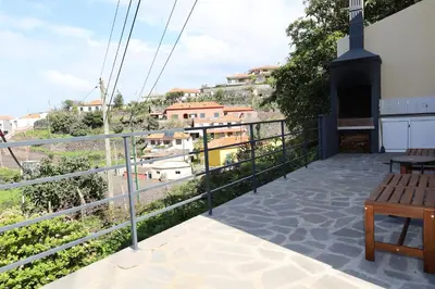 a balcony with a view of a city at Casa das Feiteiras by AnaLodges in Ponta Delgada