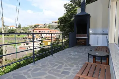 a balcony with a view of a city at Casa das Feiteiras by AnaLodges in Ponta Delgada