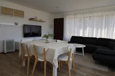 a living room with a table and chairs and a couch at Casa das Feiteiras by AnaLodges in Ponta Delgada
