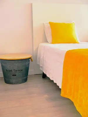a bedroom with a bed and a trash can at top floor arriaga apartment 804 in Funchal