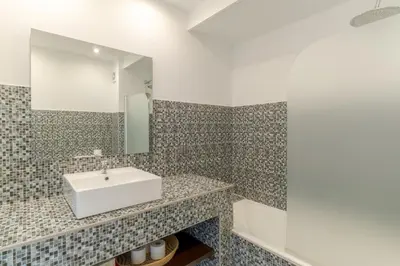 a bathroom with a sink and a mirror at top floor arriaga apartment 804 in Funchal