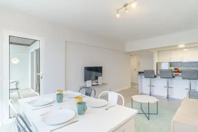 a kitchen and living room with a table and chairs at top floor arriaga apartment 804 in Funchal