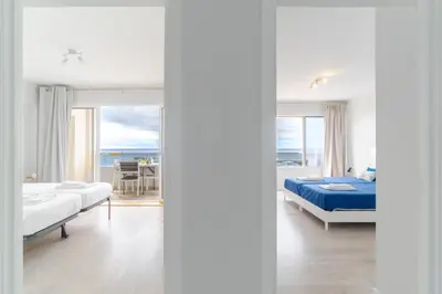 a bedroom with two beds and a view of the ocean at top floor arriaga apartment 804 in Funchal