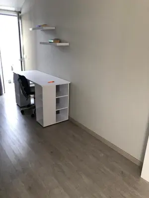 an office cubicle with a white desk and a chair at Casa das Palmeiras in Calheta