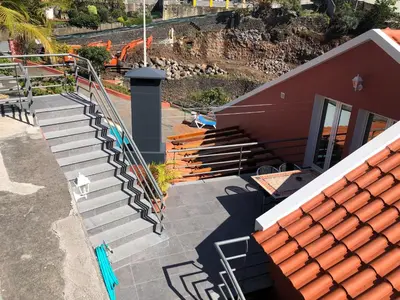 an overhead view of a staircase next to a building at Casa das Palmeiras in Calheta