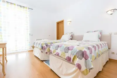 a bedroom with two beds and a window at CoolHouses Algarve Luz, Ocean front 4 Bed house w/ pool, Casa da Pipa in Luz