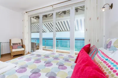 a bedroom with a large bed and a large window at CoolHouses Algarve Luz, Ocean front 4 Bed house w/ pool, Casa da Pipa in Luz