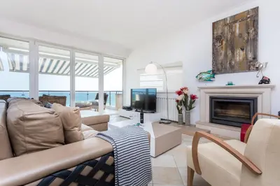 a living room with a couch and a fireplace at CoolHouses Algarve Luz, Ocean front 4 Bed house w/ pool, Casa da Pipa in Luz