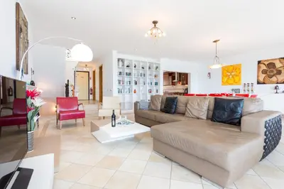 a living room with a couch and a table at CoolHouses Algarve Luz, Ocean front 4 Bed house w/ pool, Casa da Pipa in Luz