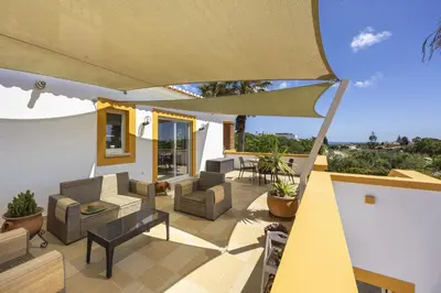 a bedroom with a blue bed and a mirror at CoolHouses Algarve Luz, 2 Bed semi detached villa, Jardim das Palmeiras condominium, Villa A in Montinhos da Luz