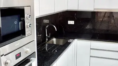 a kitchen with a sink and a microwave at Villa Cassolino in Ribeira Brava