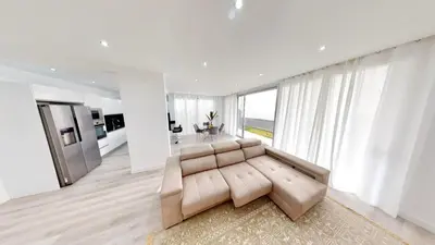 a living room with a couch and a large window at Villa Cassolino in Ribeira Brava