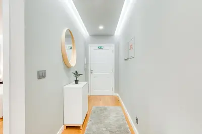 a hallway with a white door and a mirror at Casa da Praia by Amazing Madeira in Caniço
