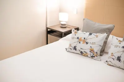a bedroom with a bed with two pillows on it at Casa da Praia by Amazing Madeira in Caniço