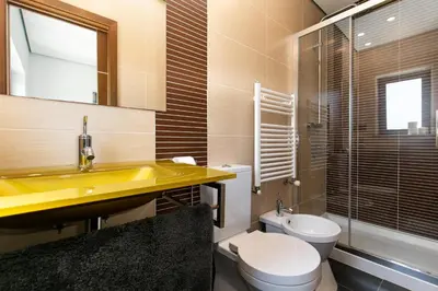 a bathroom with a yellow sink and a toilet at Casa Amizade in Aljezur