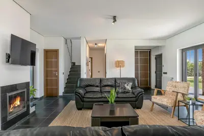 a living room with a couch and a fireplace at Casa Amizade in Aljezur
