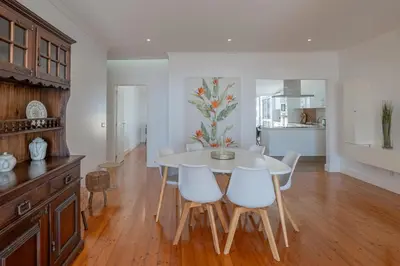 a kitchen and dining room with a table and chairs at Centre Funchal top floor terrace & large balconies in Funchal