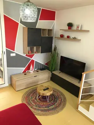 a living room with a table and a television at Charming Beach Villa Porto Santo in Porto Santo