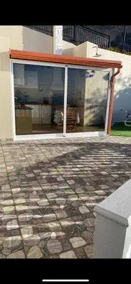 a building with a patio with a stone floor at Slice of Ponta do Sol - Suite 2 in Canhas
