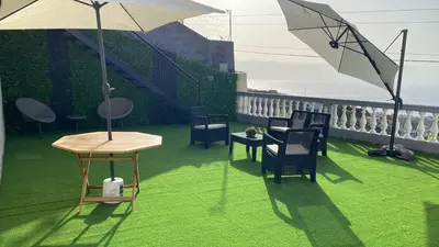 a patio with chairs and a table and an umbrella at Slice of Ponta do Sol - Suite 2 in Canhas