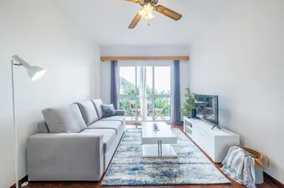 a living room with a couch and a tv at Sol&mar in Ponta do Sol