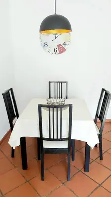 a dining room table with two chairs and a chandelier at Apartamento do Corpo Santo in Funchal