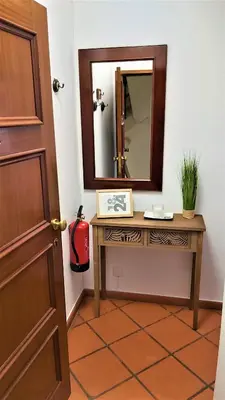 a bathroom with a table and a mirror at Apartamento do Corpo Santo in Funchal