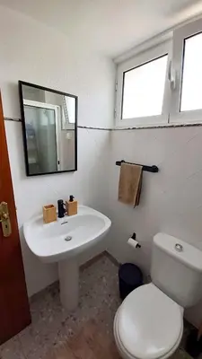 a bathroom with a sink and a toilet and a mirror at Apartamento do Corpo Santo in Funchal