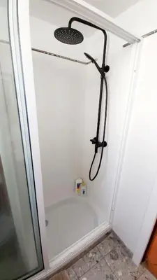 a shower in a white bathroom with a shower at Apartamento do Corpo Santo in Funchal