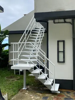 a bedroom with a bed with blue sheets and a window at Ocean Garden, 4 units by the ocean in São Vicente